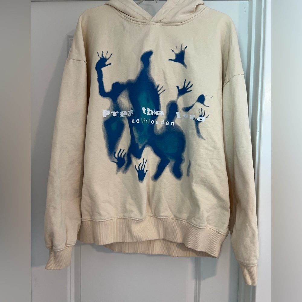 Women’s Aelfric Eden Cream Hoodie featuring blue "Pray the Lord" design. Medium.